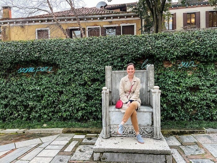 A woman poses inside the garden of the Peggy Guggenheim Collection in Venice.
