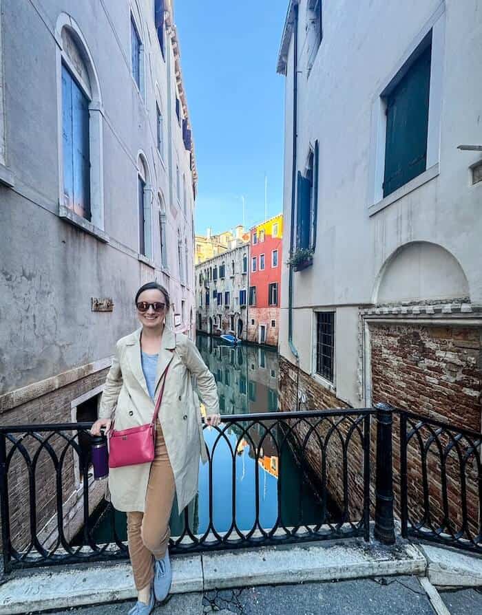 A woman poses on one of the many bridges in Venice, Italy.