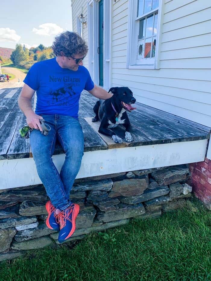A man pets his dog at Dog Mountain in Vermont.