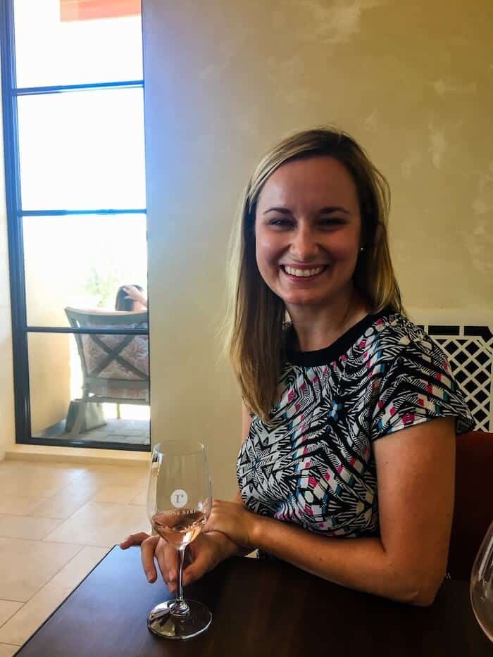 A woman sips on wine at a winery in Oregon.