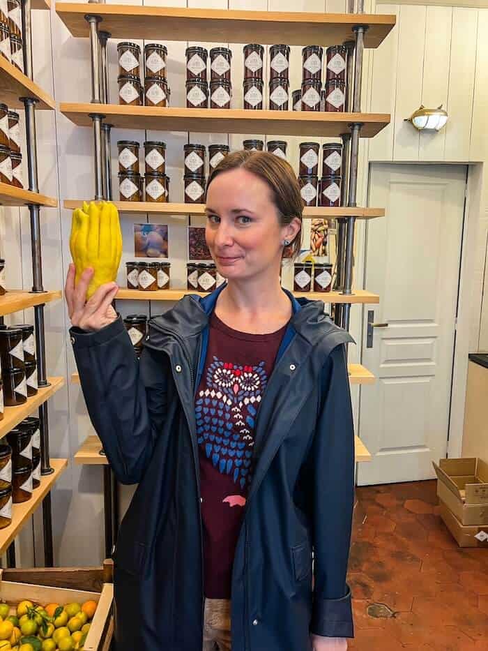 A woman holds a very unique fruit in Paris.