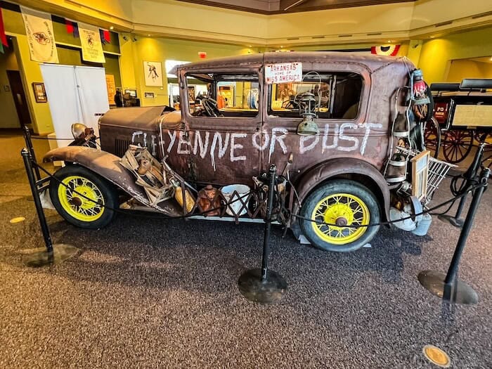 An old truck painted with the words "Cheyenne or bust" on it