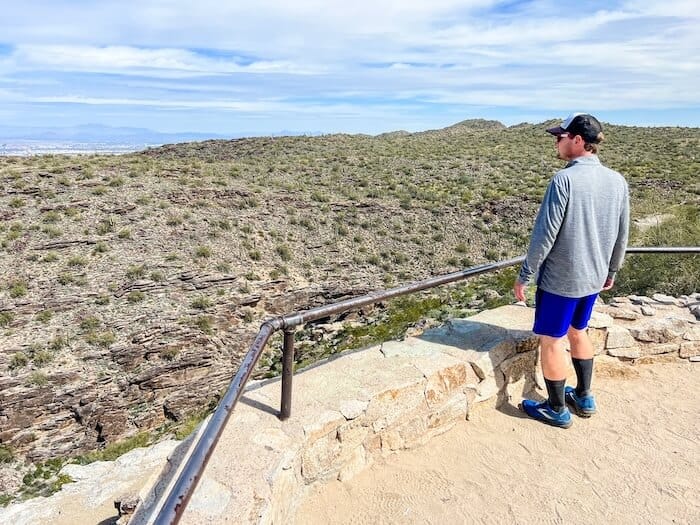 A man looks out at a Phoenix landscape.