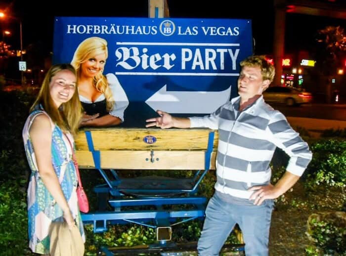 A couple poses at a sign for a beer hall in Las Vegas.