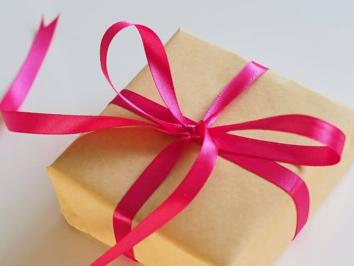 A gift wrapped with a hot pink ribbon