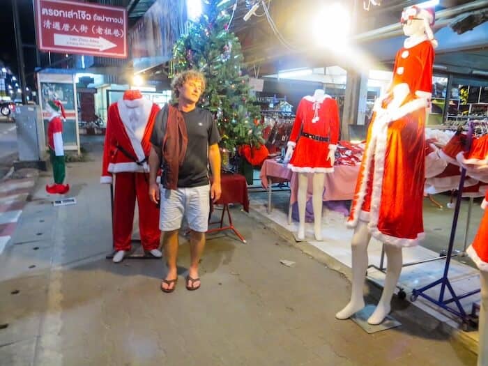 A man surrounded by Christmas decor in Chiang Mai