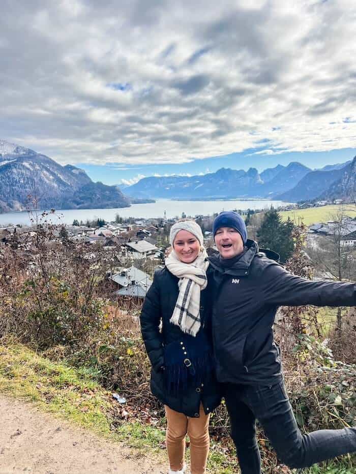 A couple poses on a trip to the mountains of Austria.