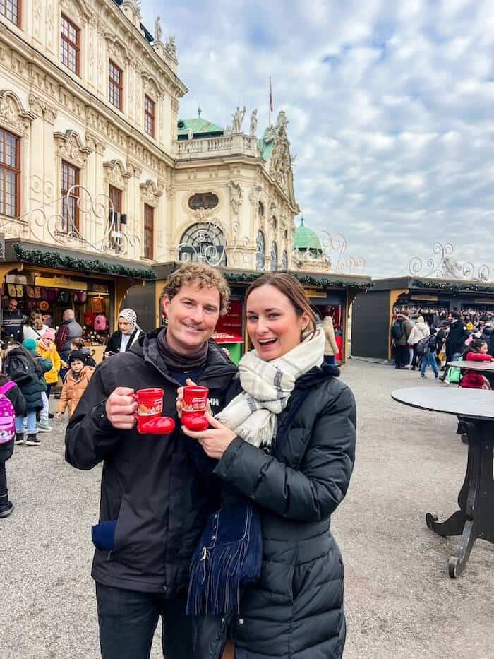 A couple poses at a market in Austria.