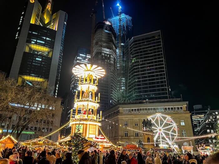 A crowded Christmas market in Frankfurt at night