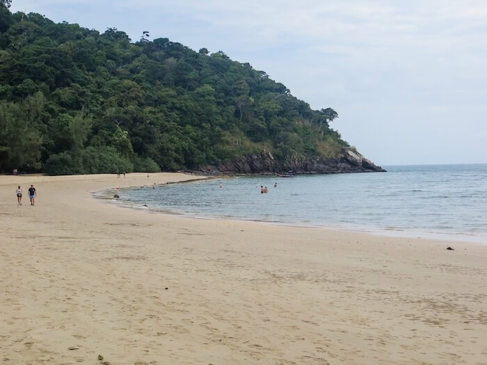 People stroll along the beach.