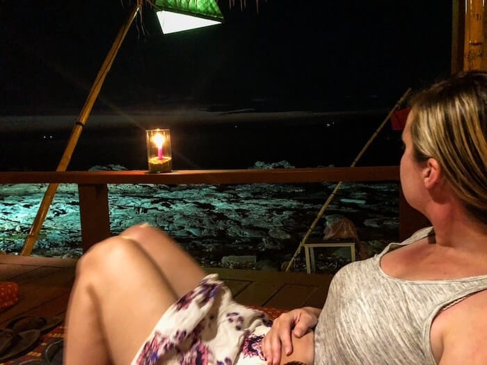 A woman relaxes at a beach bar.