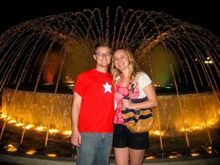 A couple poses at a water fountain show in Lima, Peru.