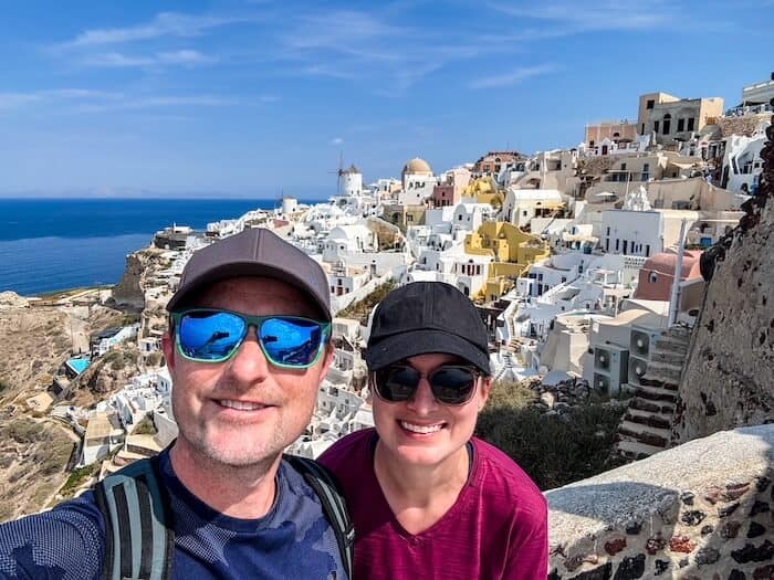 A couple takes a selfie in Oia in Santorini.