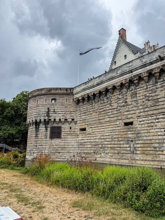 A flag at a chateau in Nantes blows in the breeze.
