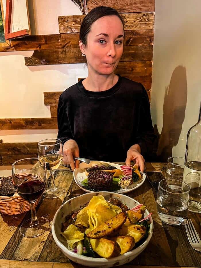 A woman gets ready to eat lots of tasty food.