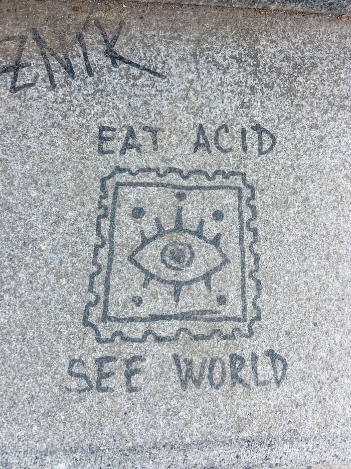 A weird sign in Prague: Eat Acid, See World