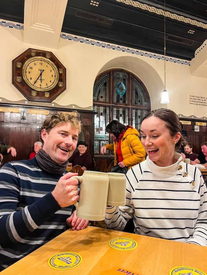 A couple gets ready to drink some beer at a brewery in Salzburg.