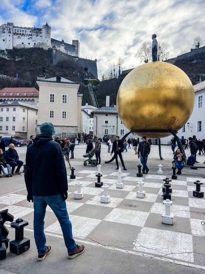 A golden globe and giant chessboard at Kapitelplatz in Salzburg