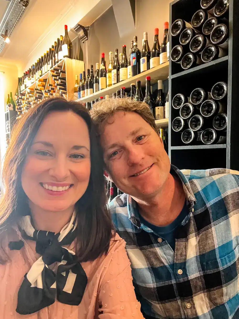A couple poses at a Champagne bar in Paris, France.