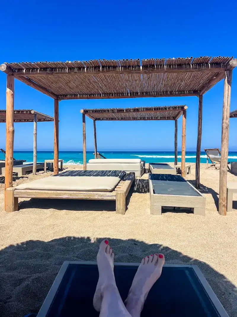 A woman relaxes on a beach in Crete.