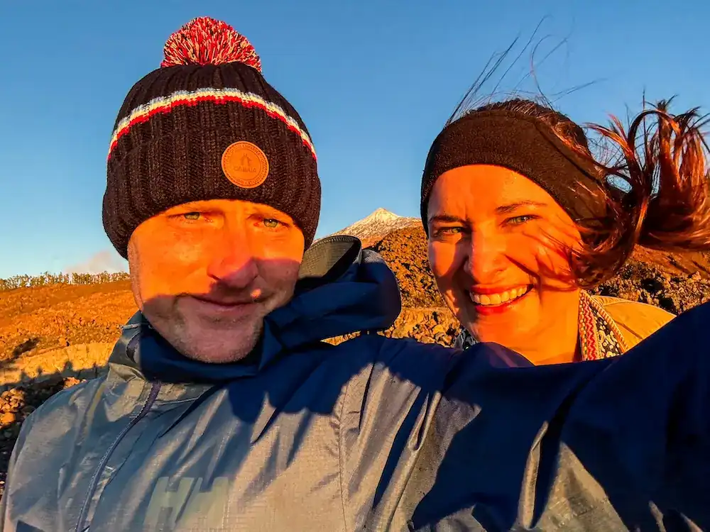 A couple gets ready to do some stargazing in Tenerife, while the wind whips their hair.