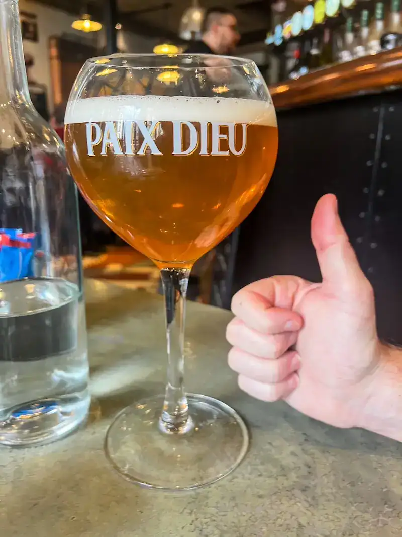 A man gives a thumbs up to a beer in France.