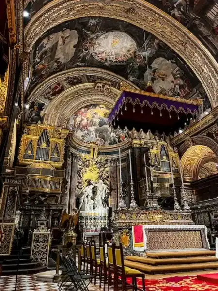 The ornate interior of a cathedral in Valletta, Malta