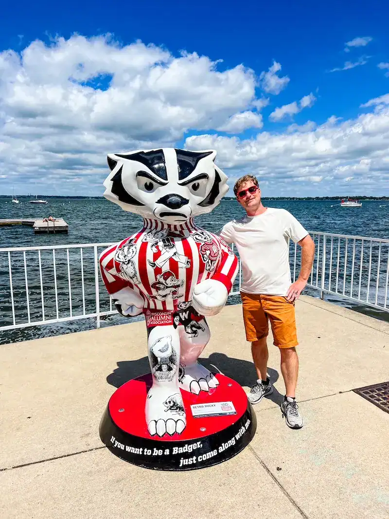 A man poses with the Wisconsin Badger.