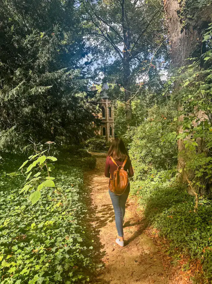 A woman walks through the gardens at the Château de Monte-Cristo.