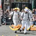 Men carry wheels of cheese at the Alkmaar cheese market.