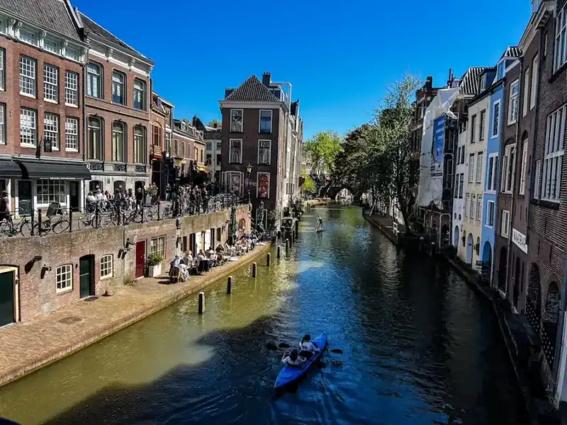 Boats float down a canal in Utrecht.