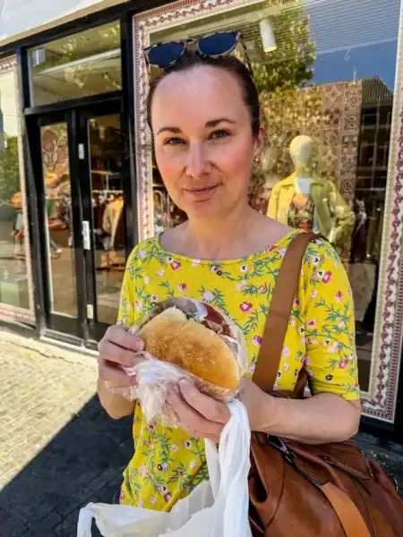 A woman eats a sandwich at Broodje Mario in Utrecht.
