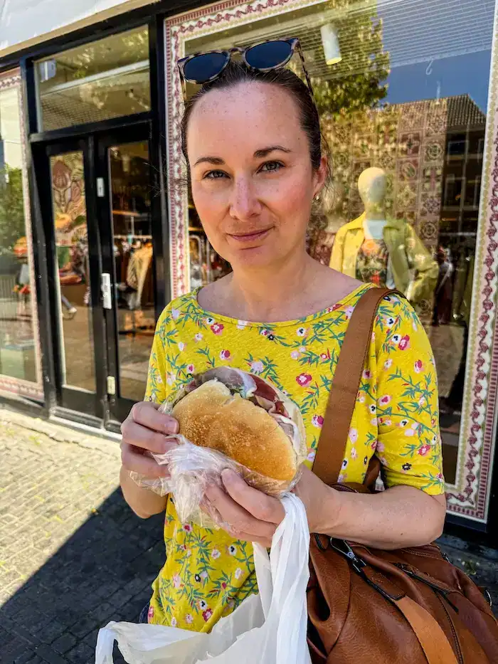 A woman eats a sandwich at Broodje Mario in Utrecht.