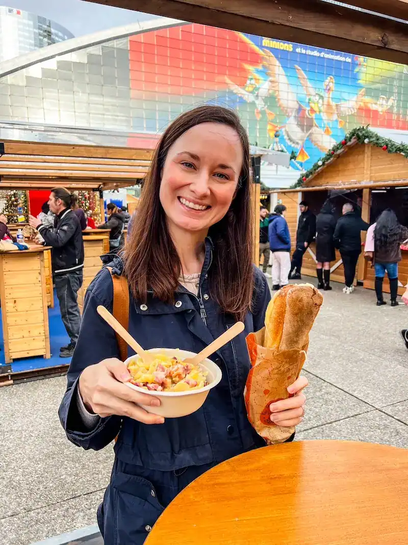 A woman eats a baguette in France.