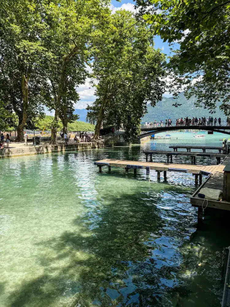 A crowd gathers at a popular bridge in Annecy.