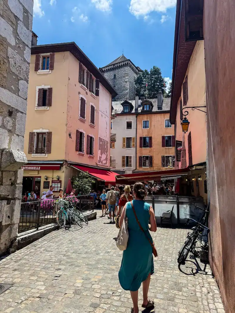 A woman walks to the Château d'Annecy in Annecy.