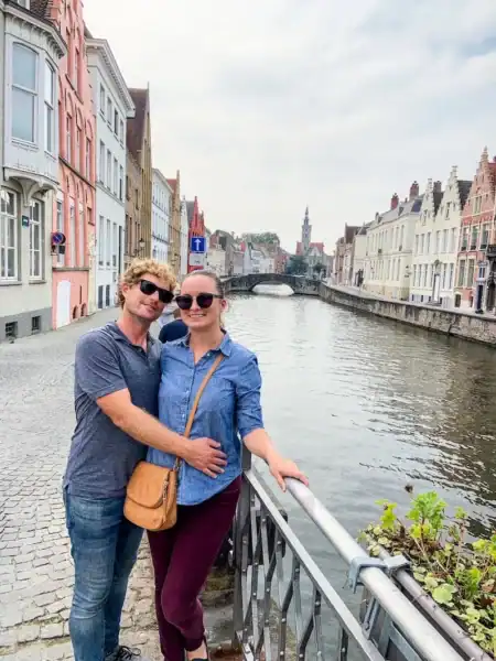 A couple poses in Bruges on a Belgium itinerary.
