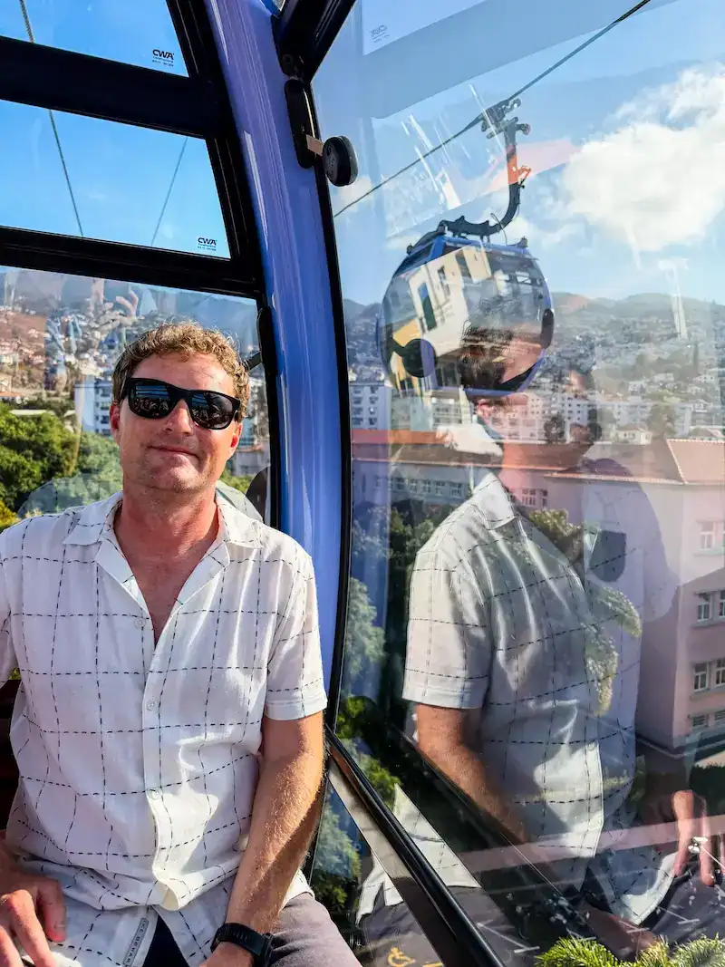 A man rides a gondola in Madeira.
