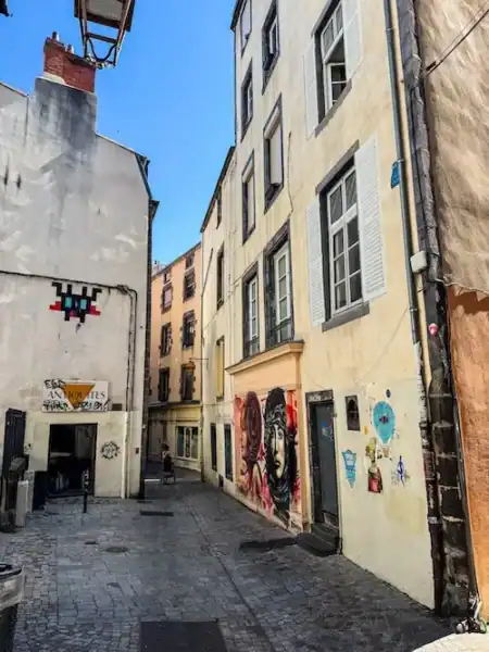 An alleyway with street art in Clermont-Ferrand near volcanoes in France