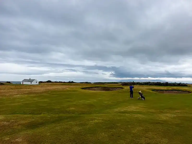 A man gets ready to golf near Belfast.