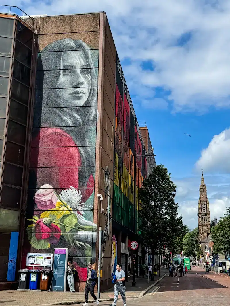 A large mural in Belfast of a solemn girl