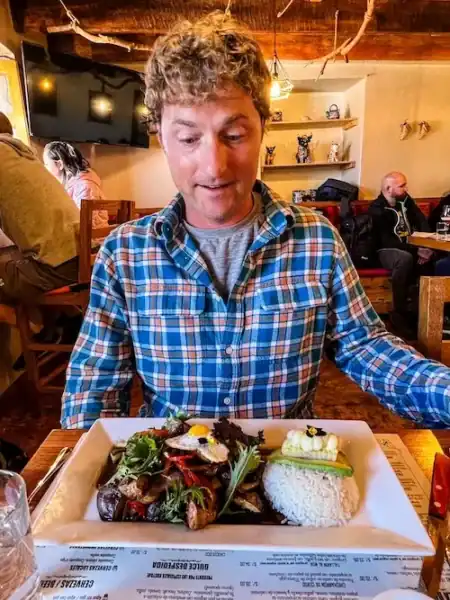 A man gets ready to eat a large plate of food in Cusco.