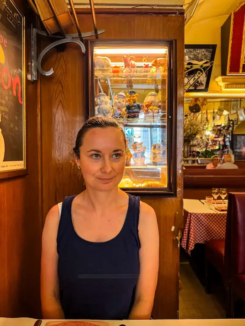 A woman poses in a bouchon in Lyon.