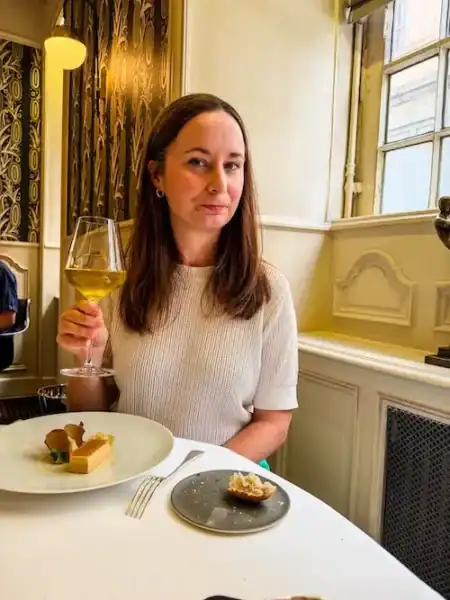 A woman gets ready to eat a tasty meal in Lyon.