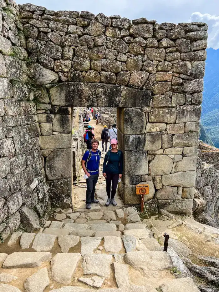 A couple poses on a circuit at Machu Picchu.