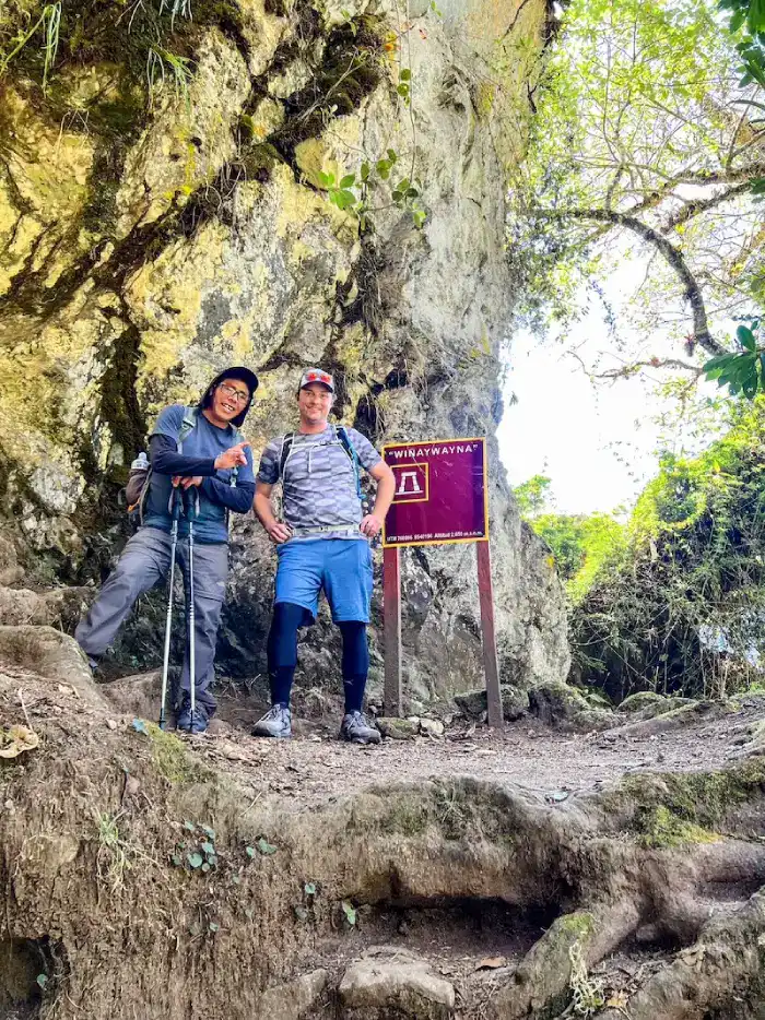 A man poses with a guide on the Inca Trail at Machu Picchu.