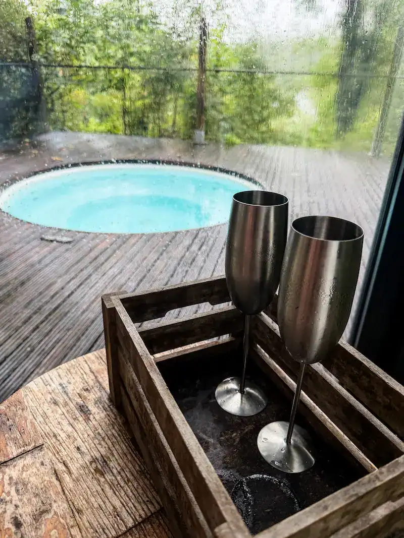Glasses of sparkling wine sit besides a hot tub in Northern Ireland.