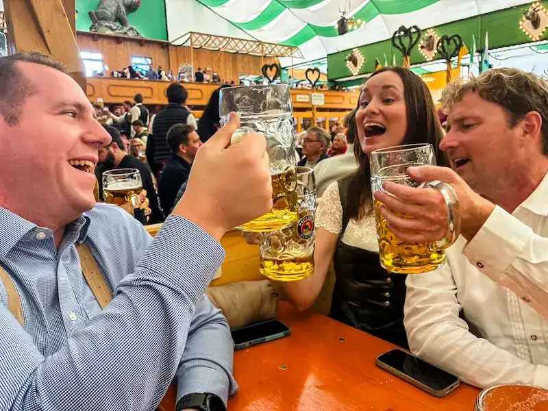 A group of friends drinks beer at Oktoberfest in Munich.
