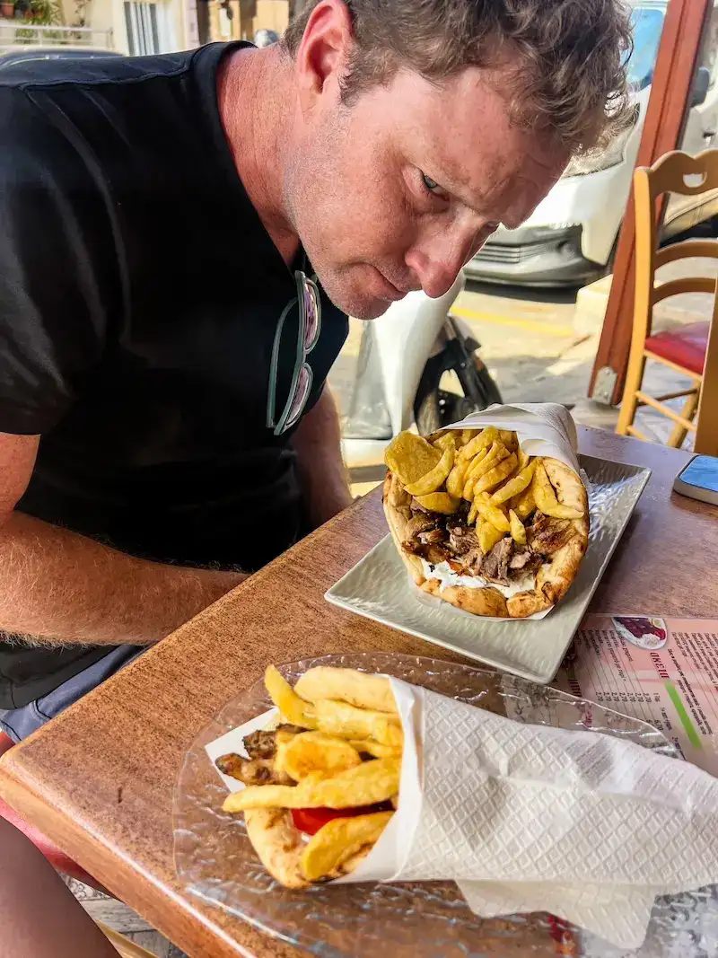 A man ponders the size of his gyros on a Crete itinerary.