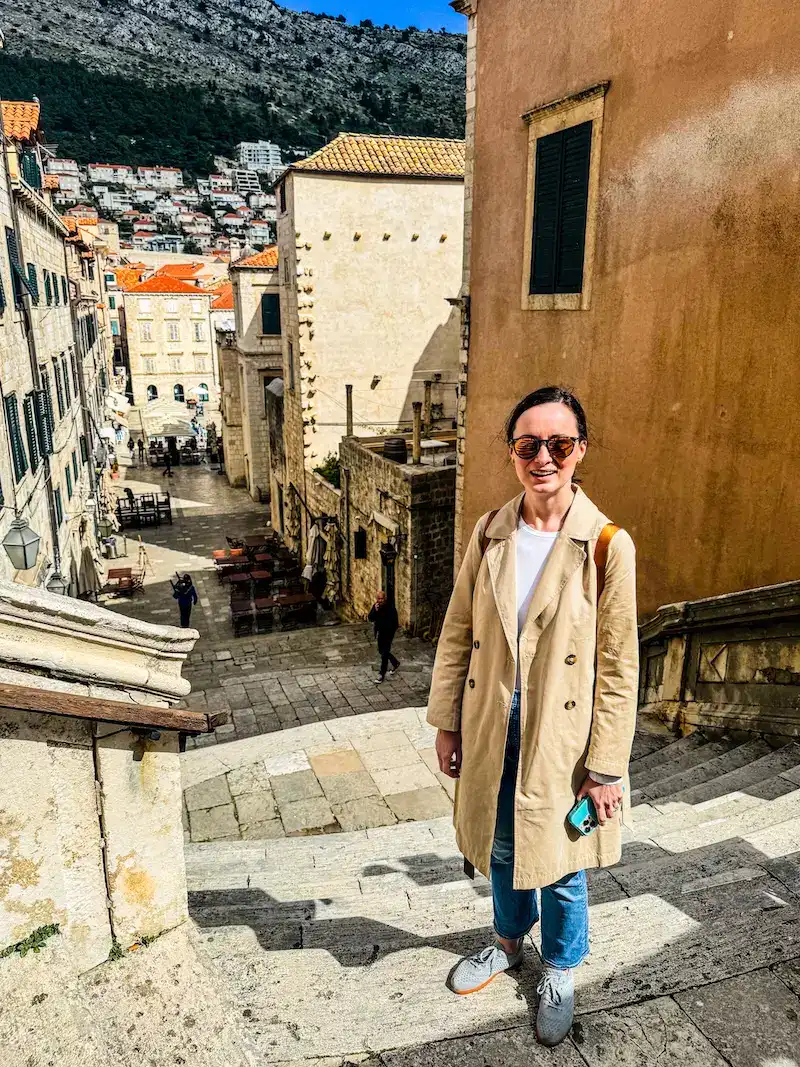 A woman stands on the Jesuit Steps during one day in Dubrovnik.